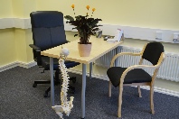 Chiropractor and patient consultation desk